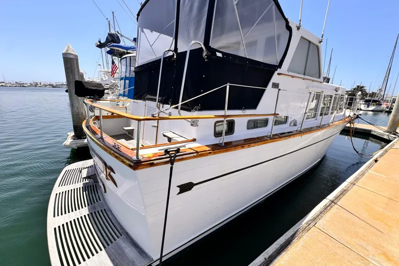 Slide: The Image of 1978 Roughwater 41 boat docked at marina under clear blue sky. - 4