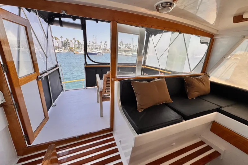 Slide: The Image of Interior of 1978 Roughwater 41 boat with seating and marina view. - 42