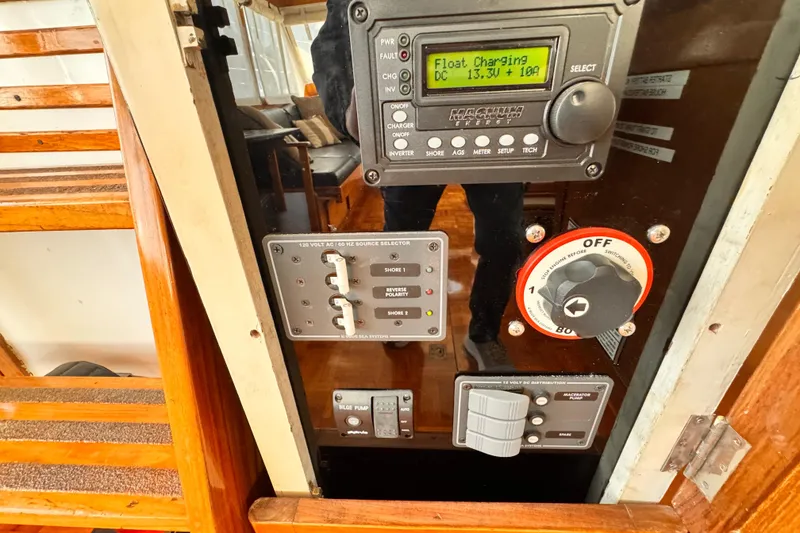 Slide: The Image of Control panel of a 1978 Roughwater 41 boat, featuring various switches and gauges. - 52