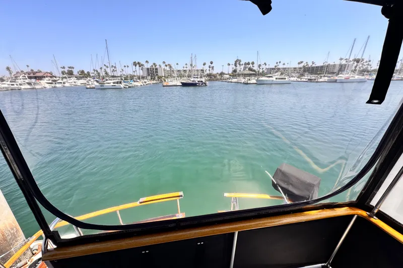 Slide: The Image of View from 1978 Roughwater 41 boat, overlooking marina with sailboats and clear blue sky. - 53