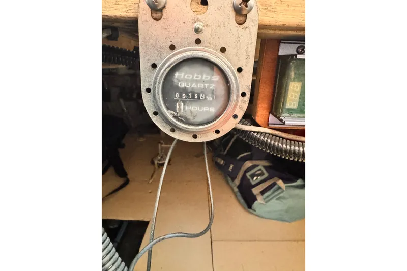 Slide: The Image of Hour meter on 1978 Roughwater 41 boat, displaying 5194 hours. - 57