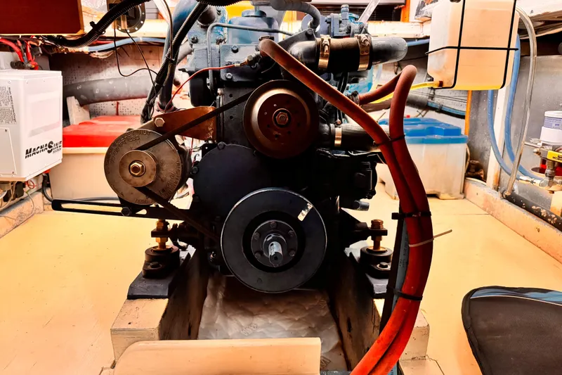 Slide: The Image of Engine room of a 1978 Roughwater 41 boat, showcasing mechanical components and wiring. - 58