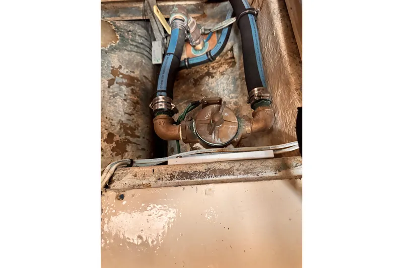 Slide: The Image of 1978 Roughwater 41 engine compartment with hoses and valve system. - 59