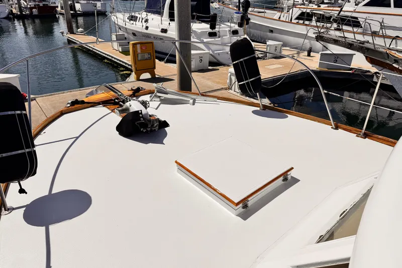 Slide: The Image of 1978 Roughwater 41 yacht docked at marina, showcasing deck and railing. - 65