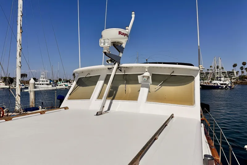 Slide: The Image of 1978 Roughwater 41 boat docked in a marina under clear blue skies. - 68