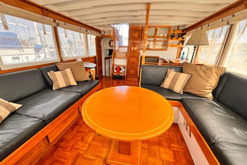 Slide: The Image of Interior of 1978 Roughwater 41 boat with wooden furnishings and cozy seating area. - 9