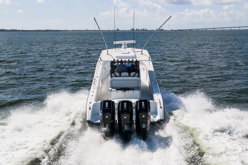 Slide: The Image of 2023 Yellowfin 42 Offshore boat cruising on open water with powerful engines. - 10