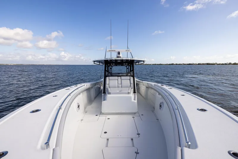 Slide: The Image of 2023 Yellowfin 42 Offshore boat on open water under clear blue sky. - 15