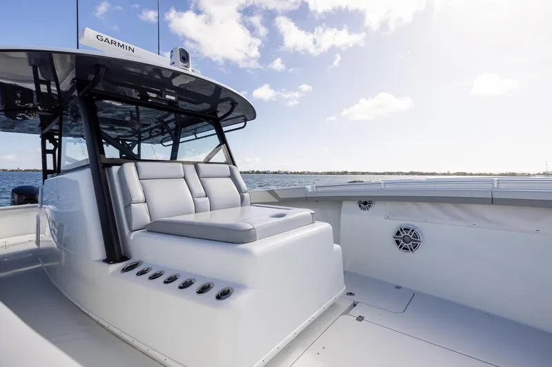 Slide: The Image of 2023 Yellowfin 42 Offshore boat with sleek seating and Garmin equipment on open water. - 16