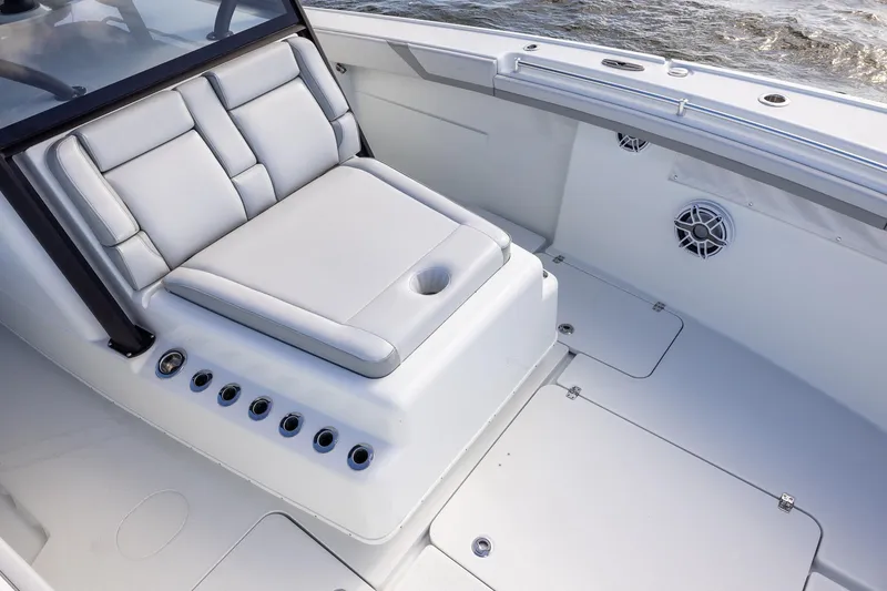 Slide: The Image of 2023 Yellowfin 42 Offshore boat interior with cushioned seating and cup holder. - 17