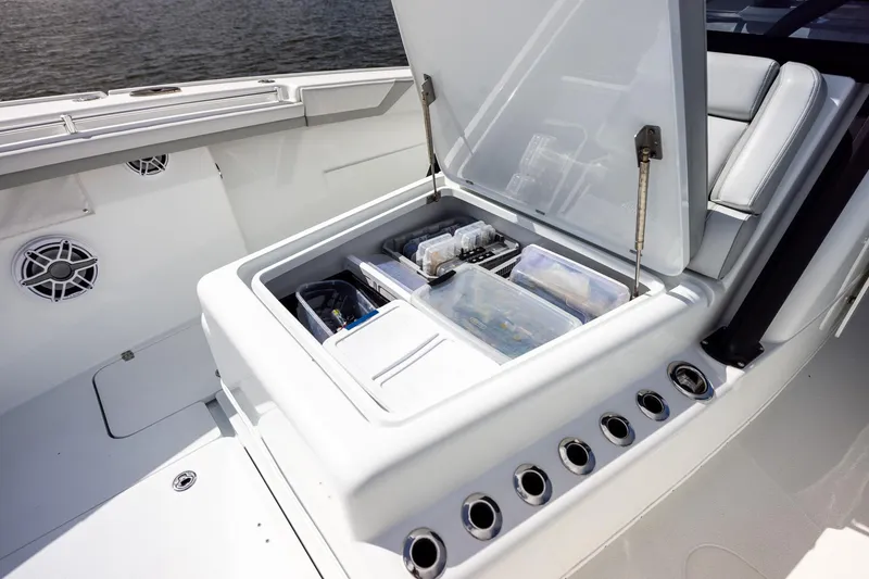 Slide: The Image of 2023 Yellowfin 42 Offshore boat storage compartment with organized fishing gear and accessories. - 18