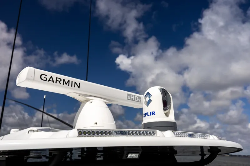 Slide: The Image of Garmin and FLIR equipment on 2023 Yellowfin 42 Offshore boat under cloudy sky. - 20