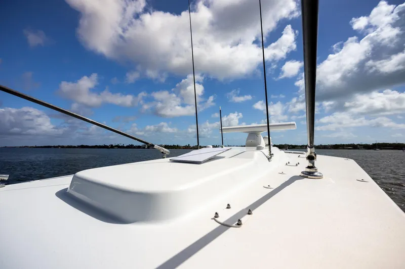 Slide: The Image of 2023 Yellowfin 42 Offshore boat deck under a bright blue sky. - 21