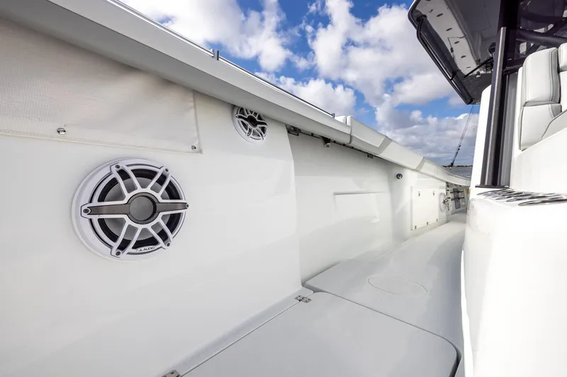 Slide: The Image of 2023 Yellowfin 42 Offshore boat interior with JL Audio speakers, under a partly cloudy sky. - 22