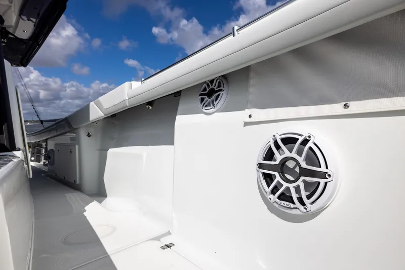 Slide: The Image of 2023 Yellowfin 42 Offshore boat deck with speakers under a blue sky. - 23