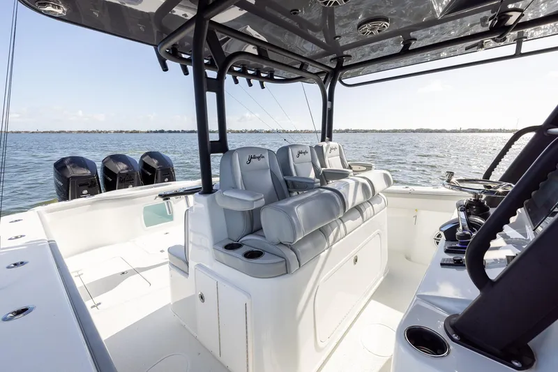 Slide: The Image of 2023 Yellowfin 42 Offshore boat interior with seating and controls on open water. - 24