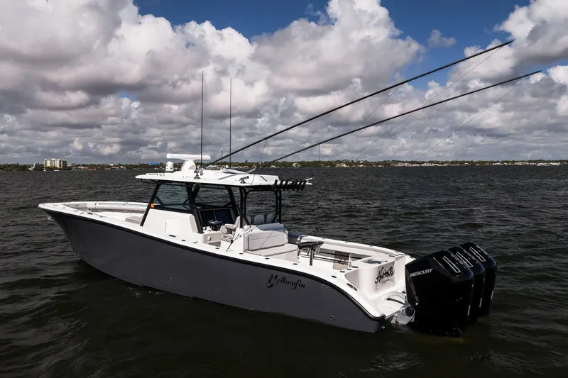 Slide: The Image of 2023 Yellowfin 42 Offshore boat on water under cloudy sky. - 3