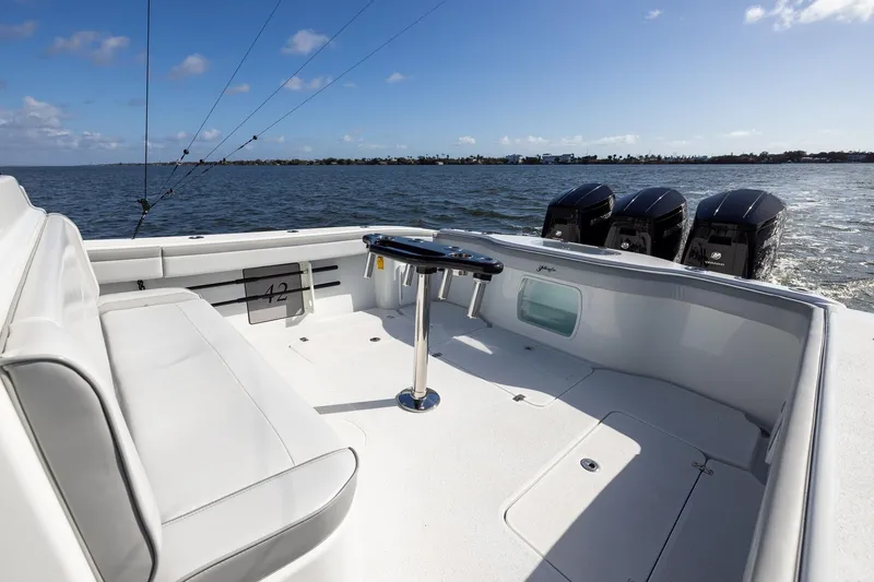 Slide: The Image of 2023 Yellowfin 42 Offshore boat with triple engines, spacious deck, and ocean view. - 32