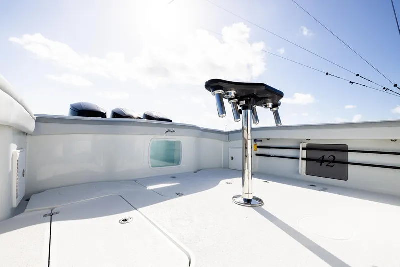 Slide: The Image of 2023 Yellowfin 42 Offshore boat deck with rod holders under a clear sky. - 34