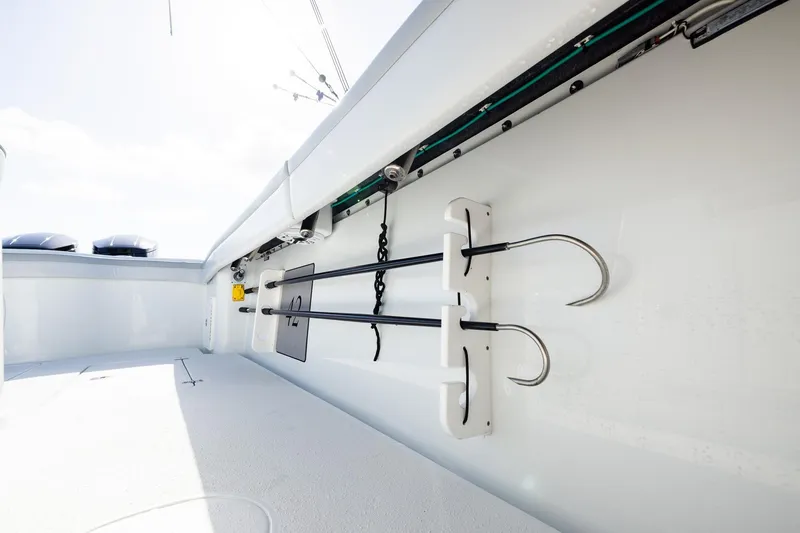 Slide: The Image of 2023 Yellowfin 42 Offshore boat interior with fishing gaffs and equipment storage. - 35