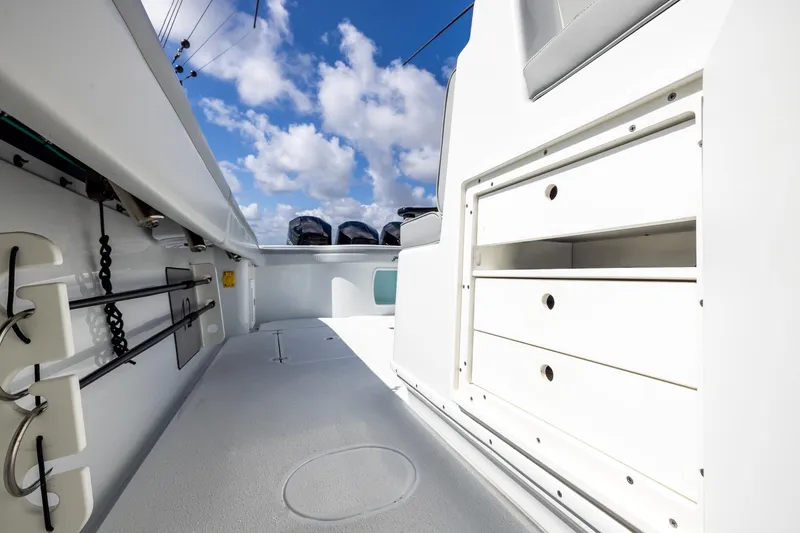 Slide: The Image of 2023 Yellowfin 42 Offshore boat interior with storage drawers and fishing rod holders. - 37