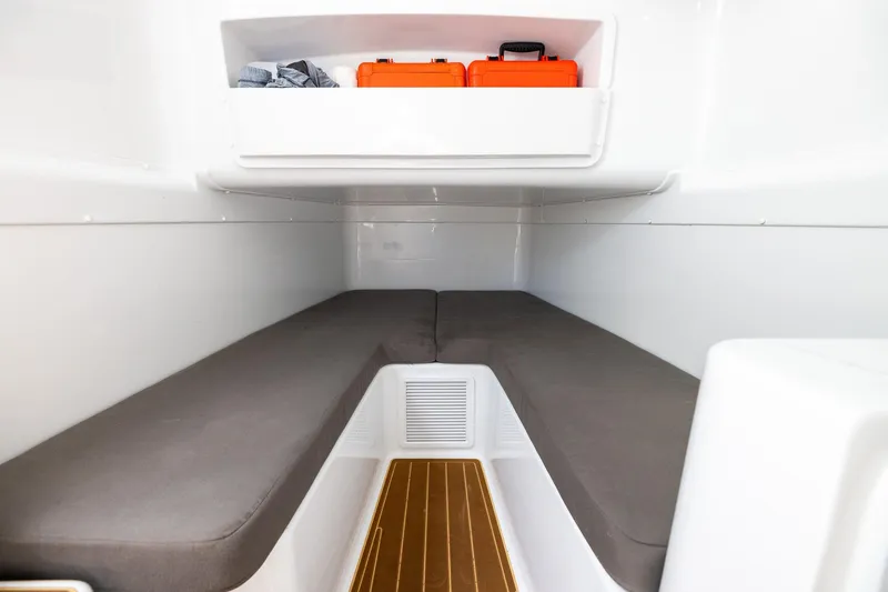 Slide: The Image of 2023 Yellowfin 42 Offshore cabin interior with storage and seating area. - 42