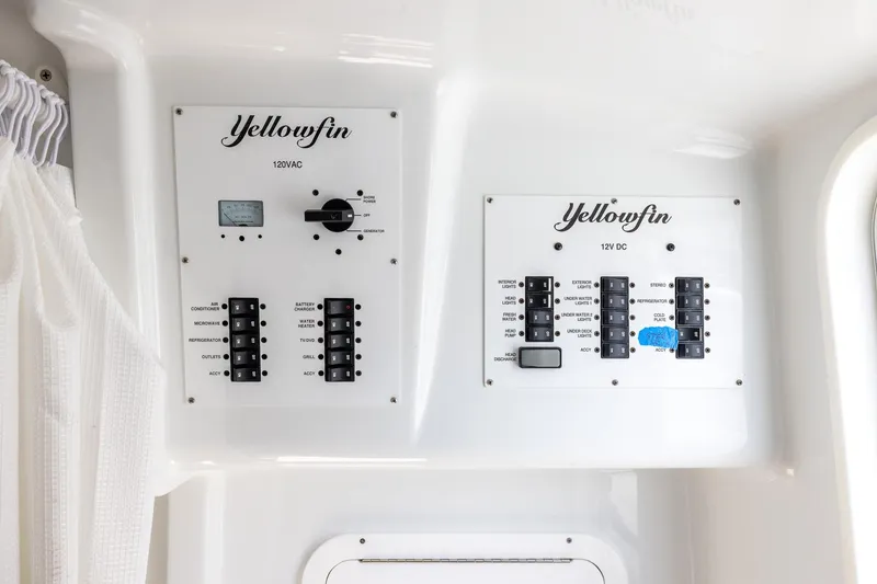 Slide: The Image of Control panel of 2023 Yellowfin 42 Offshore boat, featuring 120VAC and 12V DC systems. - 44