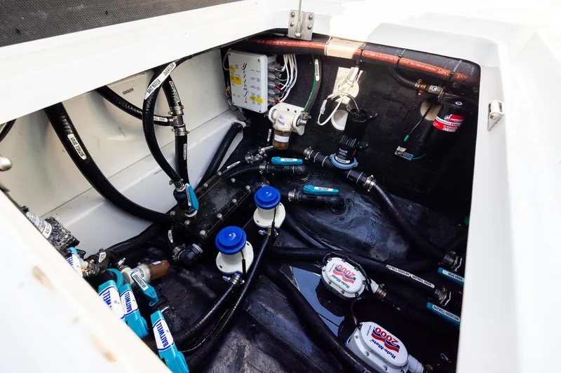 Slide: The Image of Engine compartment of 2023 Yellowfin 42 Offshore boat, showcasing intricate wiring and plumbing. - 45