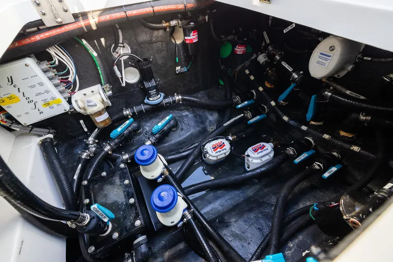 Slide: The Image of Engine compartment of 2023 Yellowfin 42 Offshore boat, showcasing intricate wiring and plumbing systems. - 46