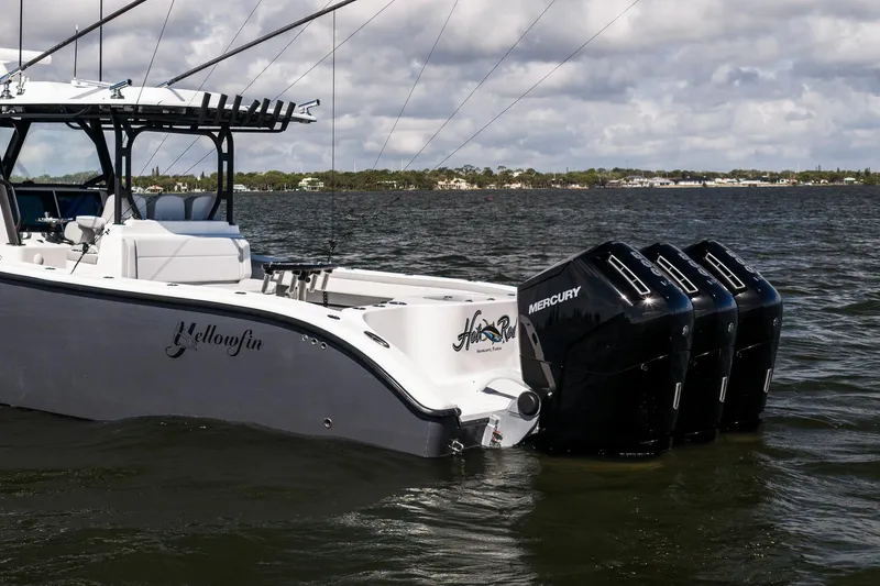 Slide: The Image of 2023 Yellowfin 42 Offshore boat with triple Mercury engines on the water. - 5