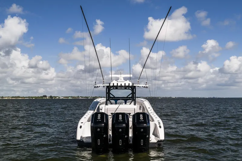 Slide: The Image of 2023 Yellowfin 42 Offshore boat with triple outboard engines on open water. - 6