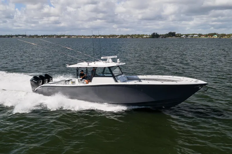 Slide: The Image of 2023 Yellowfin 42 Offshore boat cruising on open water under cloudy skies. - 8