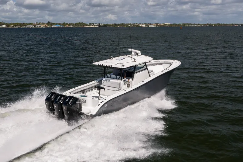 Slide: The Image of 2023 Yellowfin 42 Offshore boat cruising on open water under cloudy skies. - 9