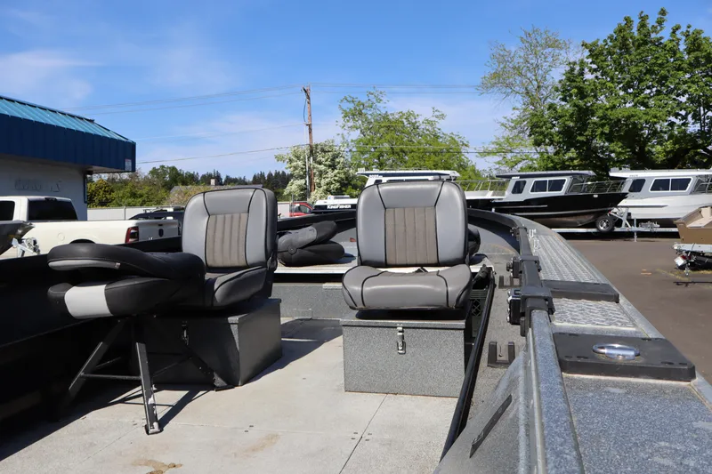 Slide: The Image of 2017 Alumaweld Super Vee LT boat interior with seating, parked outdoors. - 7
