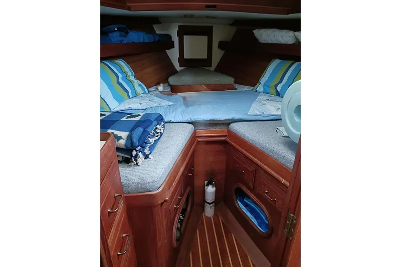 Slide: The Image of Interior of 1984 Cape Dory 31C sailboat with wooden flooring and cozy seating. - 11