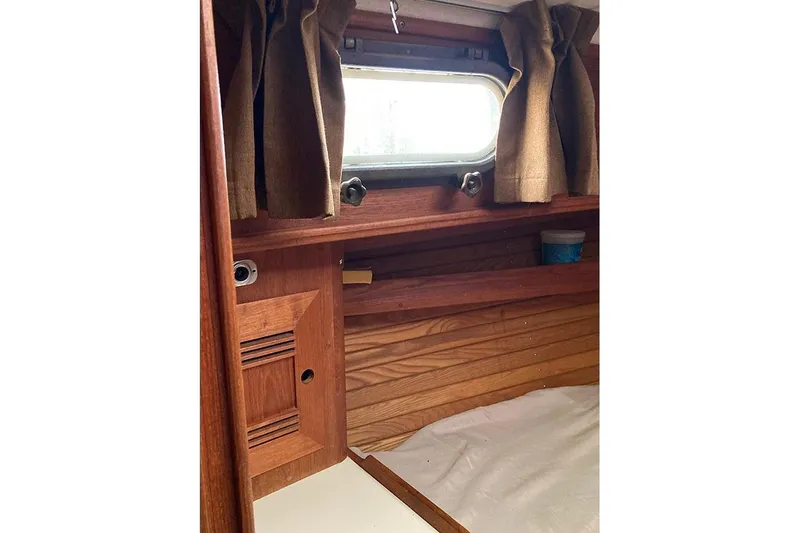Slide: The Image of Interior of 1984 Cape Dory 31C sailboat with wooden paneling and porthole window. - 15