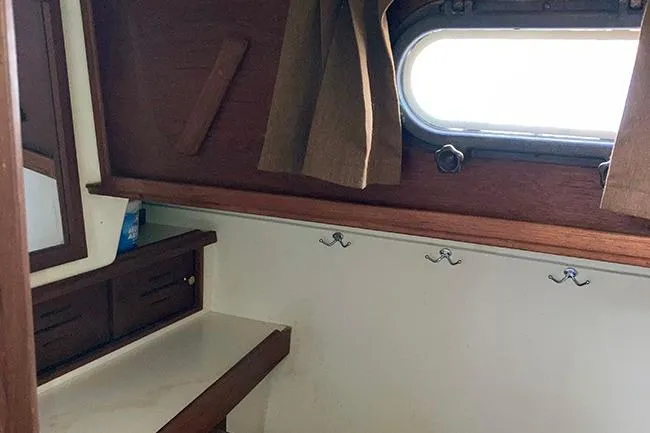 Slide: The Image of Interior of 1984 Cape Dory 31C sailboat with wooden cabinetry and porthole window. - 17