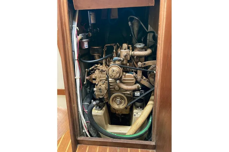 Slide: The Image of Engine compartment of a 1984 Cape Dory 31C sailboat, showcasing mechanical components. - 20