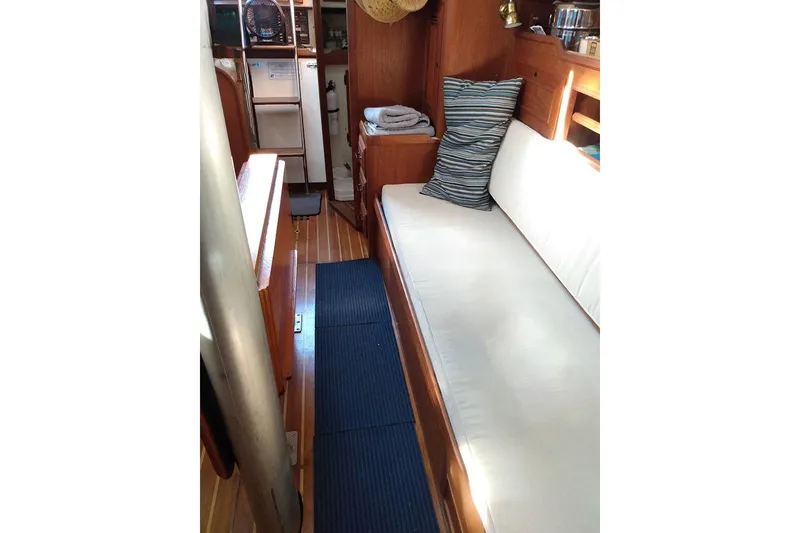Slide: The Image of Interior of 1984 Cape Dory 31C sailboat with wooden flooring and cozy seating. - 8