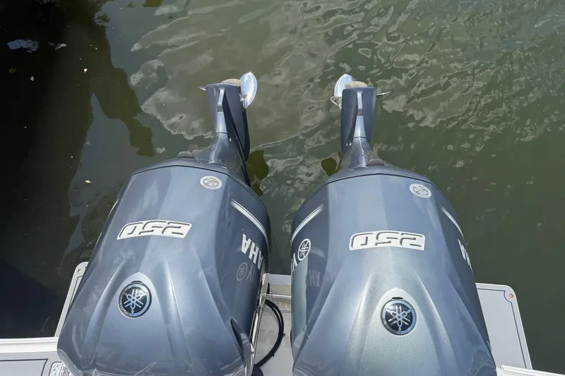 Slide: The Image of Twin Yamaha 250 outboard motors on a 2003 Intrepid 323 Cuddy boat. - 16