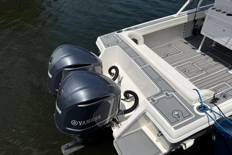 Slide: The Image of 2003 Intrepid 323 Cuddy boat with twin Yamaha outboard motors on water. - 17