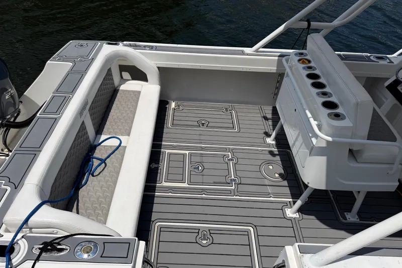 Slide: The Image of 2003 Intrepid 323 Cuddy boat interior with seating and rod holders on deck. - 18