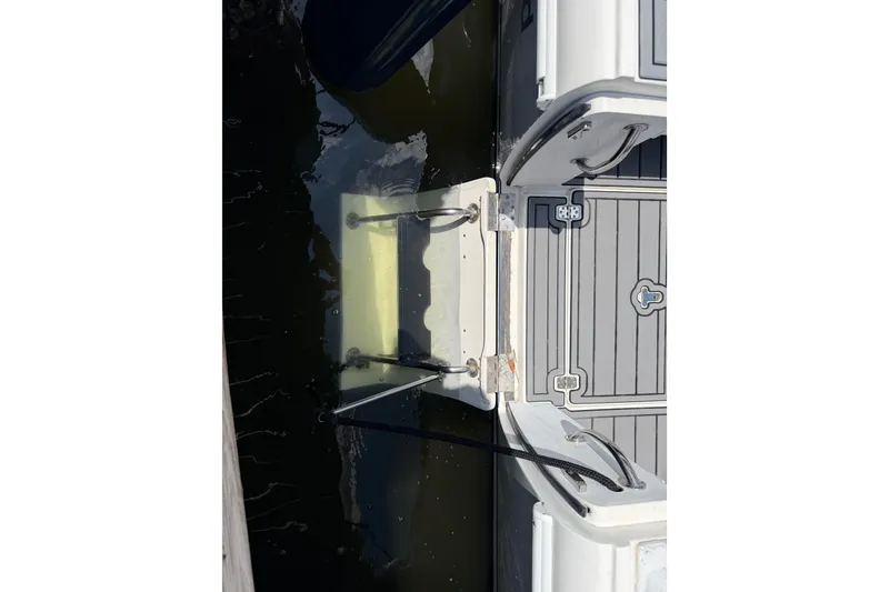 Slide: The Image of 2003 Intrepid 323 Cuddy boat swim platform with ladder in water. - 24