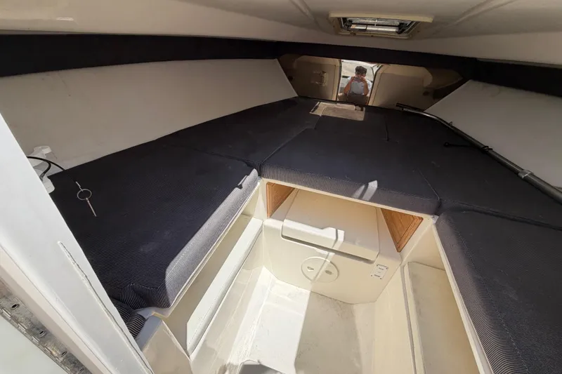 Slide: The Image of Interior cabin of a 2003 Intrepid 323 Cuddy boat, featuring cushioned seating. - 40