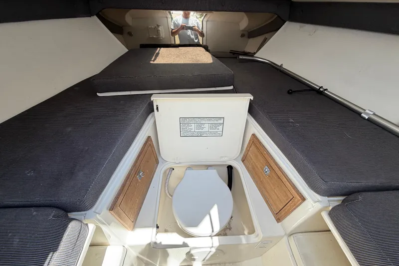 Slide: The Image of 2003 Intrepid 323 Cuddy cabin interior with seating and storage compartments. - 42