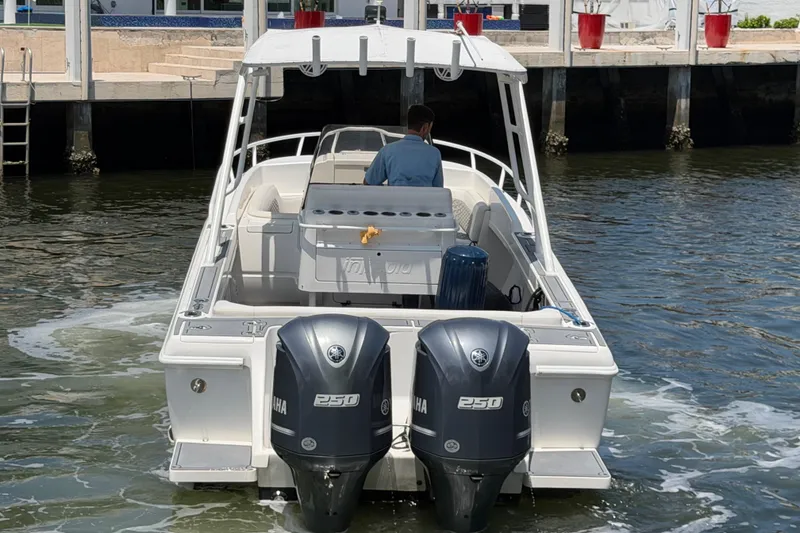 Slide: The Image of 2003 Intrepid 323 Cuddy boat with dual Yamaha 250 engines, docked in a marina. - 5