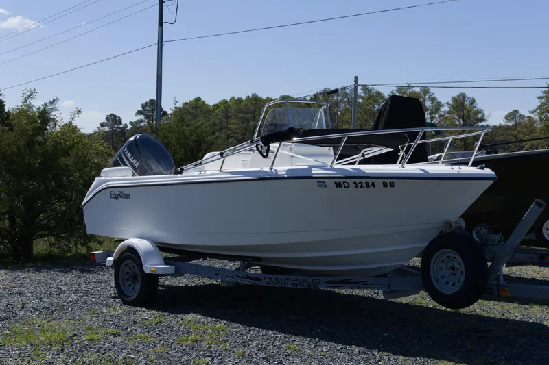 The Image of 2006 Edgewater 170CC boat on trailer, parked outdoors with Yamaha engine. - 1