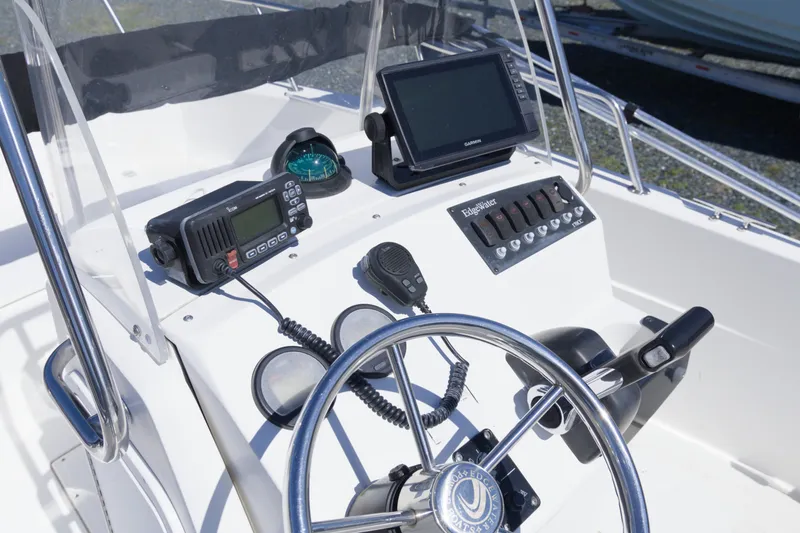 Slide: The Image of 2006 Edgewater 170CC boat console with steering wheel, GPS, and radio equipment. - 11
