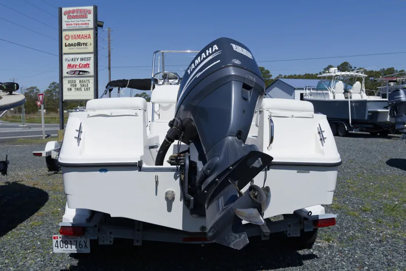 Slide: The Image of 2006 Edgewater 170CC boat with Yamaha motor at a marine dealership. - 3