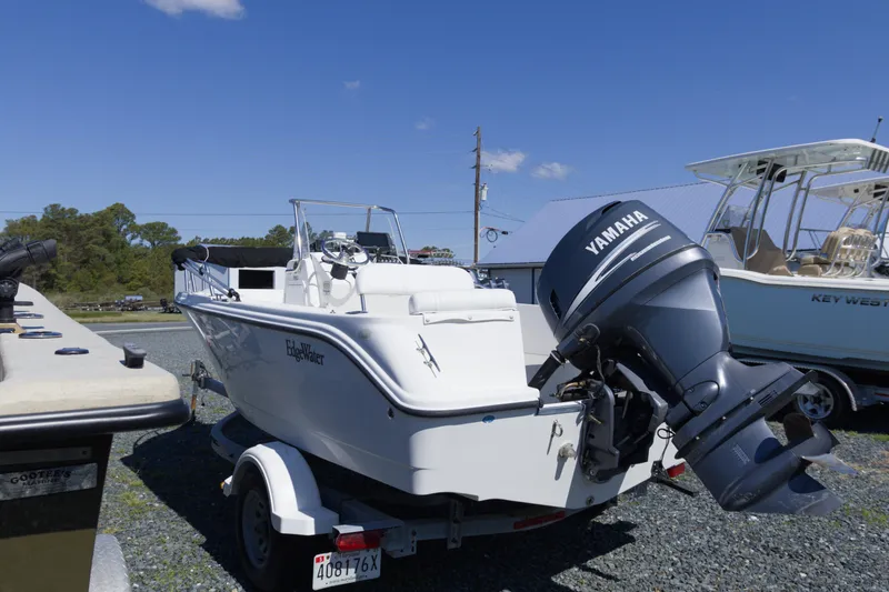 Slide: The Image of 2006 Edgewater 170CC boat with Yamaha outboard motor on trailer, parked outdoors. - 4